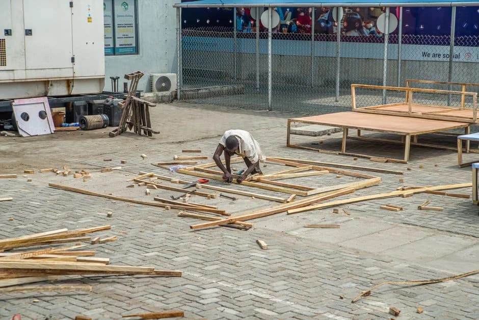 A carpenter working on a wooden frame in Lagos